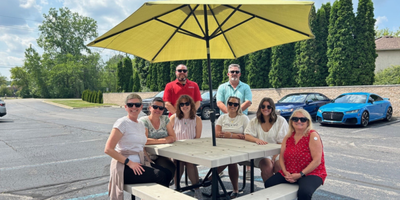 AIPMA staff at picnic table wearing sunglasses